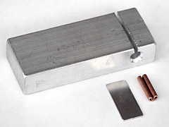 Acustom aglet crimping anvil